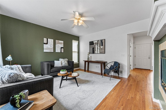 living room featuring ceiling fan and light wood-type flooring