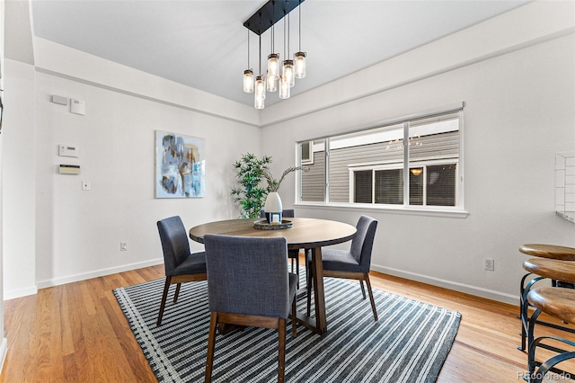 dining area with an inviting chandelier and light wood-type flooring