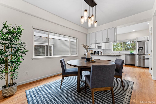 dining room featuring light hardwood / wood-style floors and a chandelier