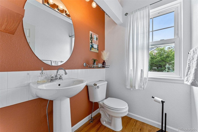 bathroom featuring wood-type flooring and toilet