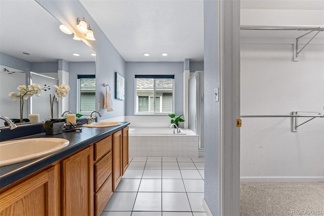 bathroom featuring tile patterned floors, independent shower and bath, and vanity