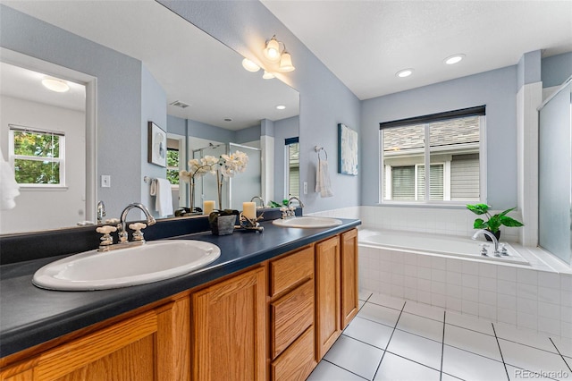 bathroom with separate shower and tub, tile patterned flooring, and vanity