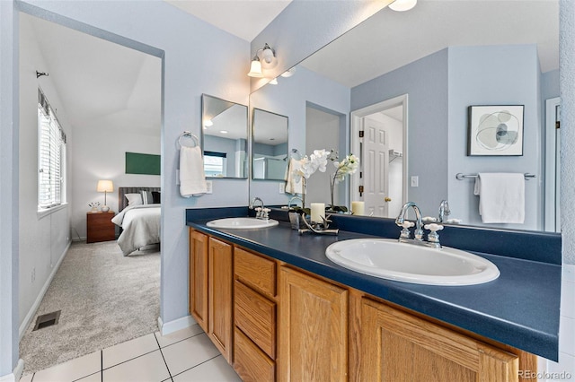 bathroom featuring tile patterned floors, vanity, and lofted ceiling