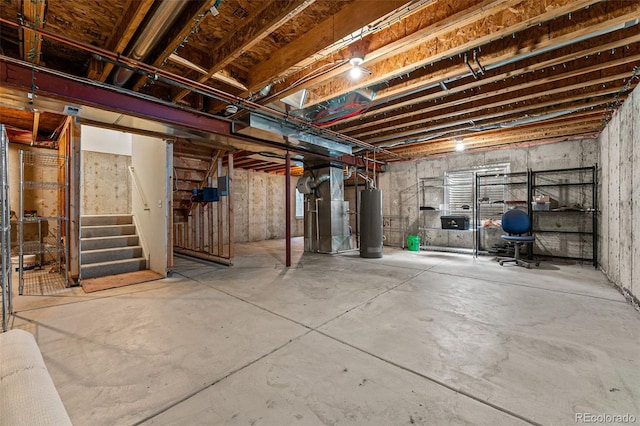 basement featuring water heater and heating unit