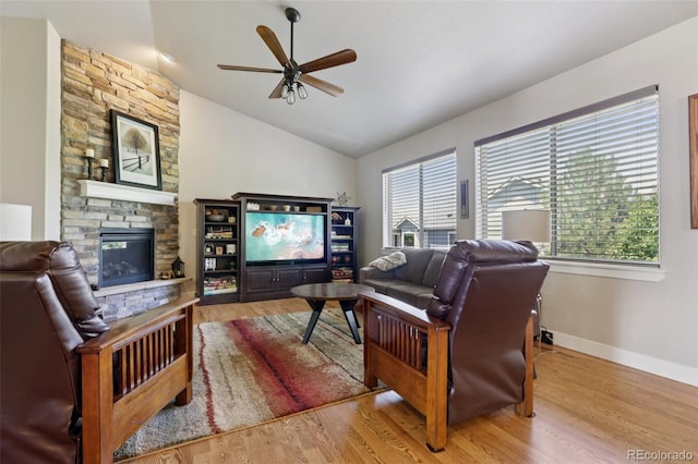 3125 Brunner Blvd, Johnstown, CO 80534 - living area featuring a ceiling fan, lofted ceiling, a stone fireplace, and wood finished floors