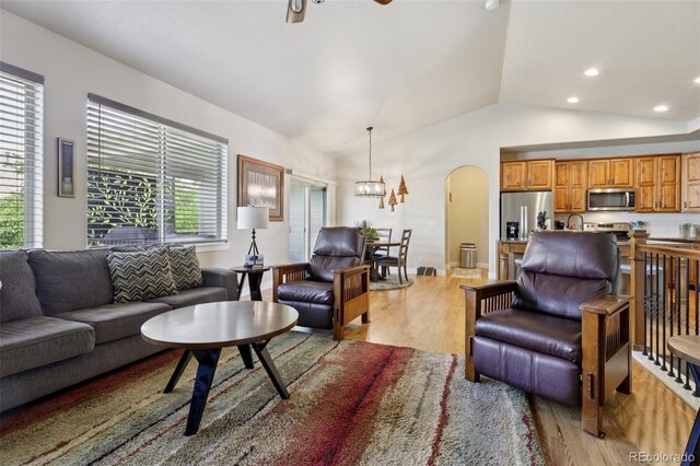 3125 Brunner Blvd, Johnstown, CO 80534 - living room featuring light wood-style flooring, arched walkways, lofted ceiling, ceiling fan, and recessed lighting