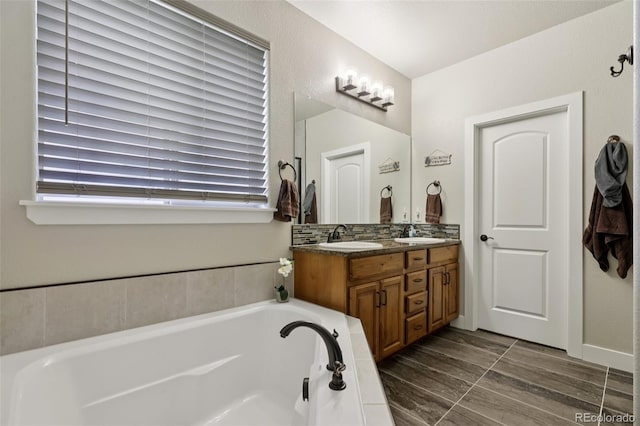 3125 Brunner Blvd, Johnstown, CO 80534 - full bathroom with double vanity, a bath, and plenty of natural light