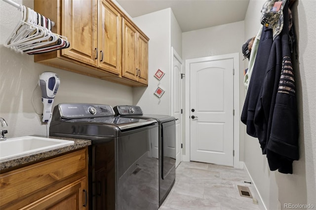 3125 Brunner Blvd, Johnstown, CO 80534 - laundry area featuring washer and clothes dryer and cabinet space