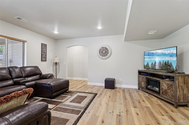 3125 Brunner Blvd, Johnstown, CO 80534 - living area featuring arched walkways, light wood-type flooring, and recessed lighting
