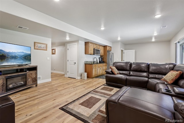 3125 Brunner Blvd, Johnstown, CO 80534 - living room with light wood-style floors and recessed lighting