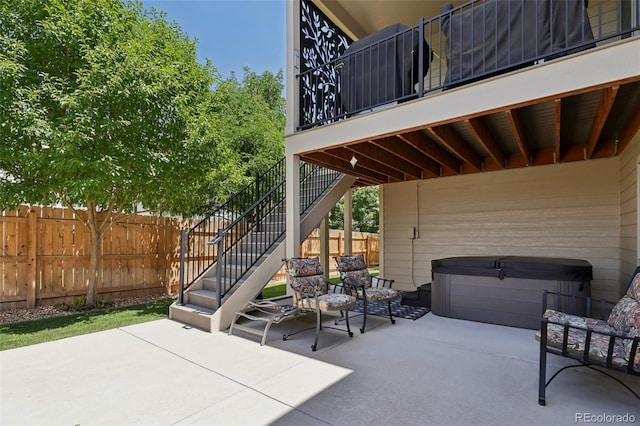 3125 Brunner Blvd, Johnstown, CO 80534 - fenced backyard with a hot tub, a patio, and stairs