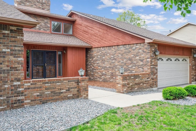 11254 E Colorado Dr, Aurora, CO 80012 - view of property exterior with a garage, a shingled roof, brick siding, and a chimney