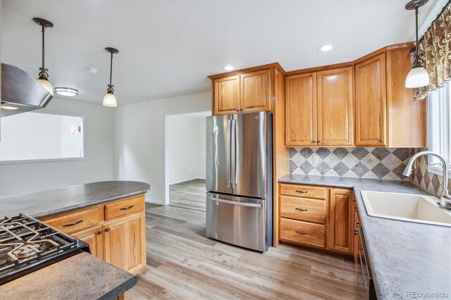 11254 E Colorado Dr, Aurora, CO 80012 - kitchen with freestanding refrigerator, decorative backsplash, light wood finished floors, pendant lighting, and recessed lighting