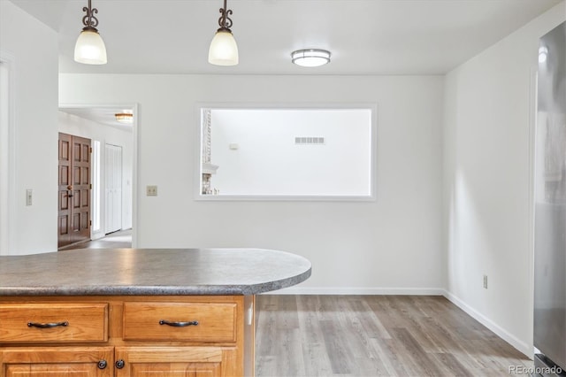 11254 E Colorado Dr, Aurora, CO 80012 - kitchen with light wood-type flooring and hanging light fixtures