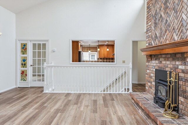 11254 E Colorado Dr, Aurora, CO 80012 - unfurnished living room featuring high vaulted ceiling and wood finished floors