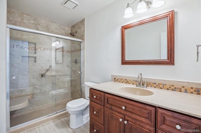 11254 E Colorado Dr, Aurora, CO 80012 - bathroom with vanity, a shower stall, and tasteful backsplash