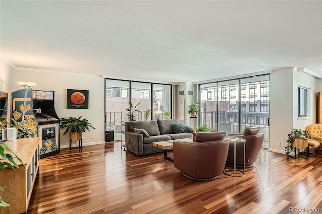 living room featuring dark hardwood / wood-style flooring, ornamental molding, and expansive windows