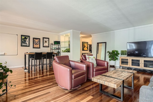 living room with hardwood / wood-style floors and crown molding