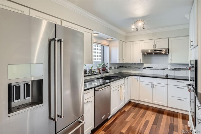 kitchen featuring sink, crown molding, tasteful backsplash, appliances with stainless steel finishes, and white cabinets