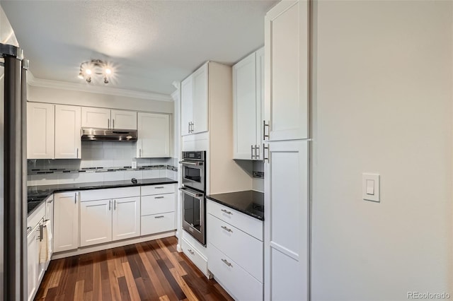 kitchen with dark hardwood / wood-style flooring, double oven, decorative backsplash, and white cabinets