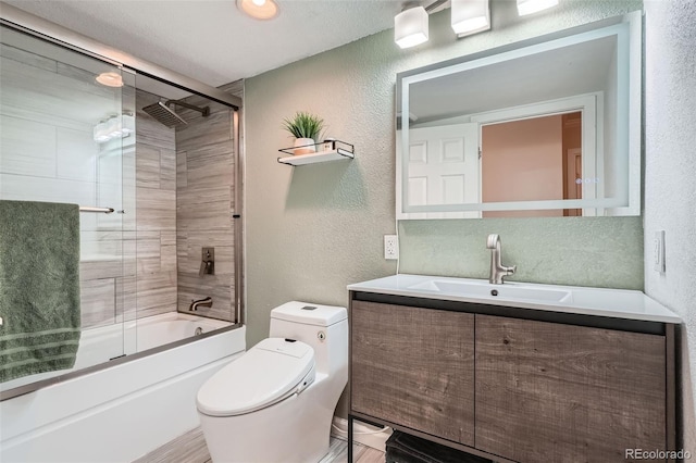 full bathroom with vanity, enclosed tub / shower combo, and toilet