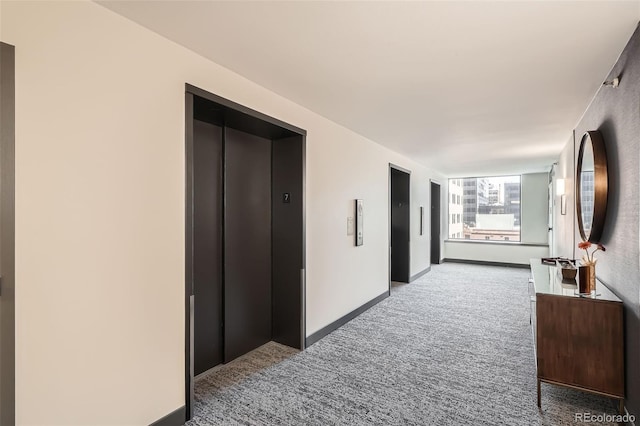 corridor with carpet floors and elevator