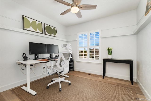 10618 Clearview Ln, Highlands Ranch, CO 80126 - home office featuring wood finished floors, ceiling fan, and baseboards