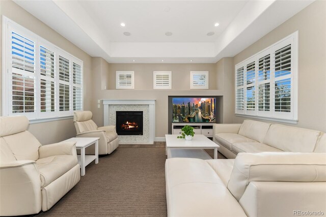 10618 Clearview Ln, Highlands Ranch, CO 80126 - living room featuring a high end fireplace, recessed lighting, a tray ceiling, plenty of natural light, and carpet