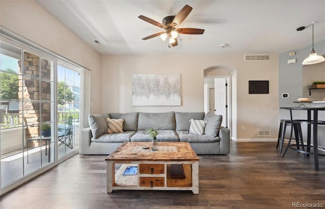 living room featuring dark hardwood / wood-style flooring and ceiling fan