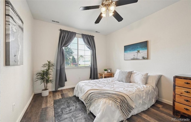 bedroom with dark hardwood / wood-style floors and ceiling fan