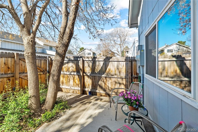 view of patio / terrace featuring fence and a residential view