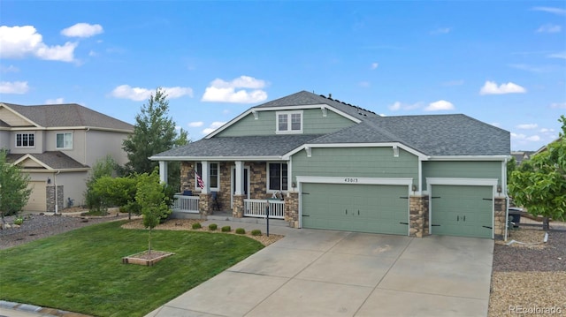 craftsman-style house featuring a garage, a front yard, and covered porch