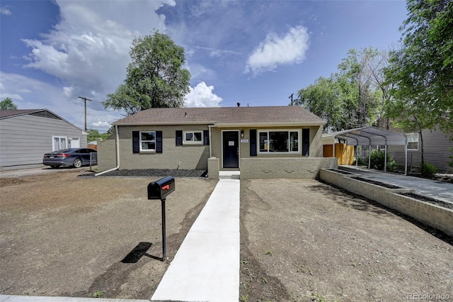 1216 Norwood Ave, Colorado Springs, CO 80905 - view of front facade with brick siding and a detached carport