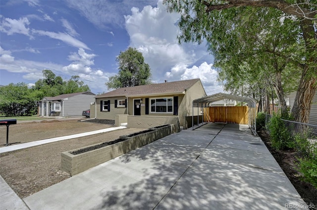 1216 Norwood Ave, Colorado Springs, CO 80905 - view of front of home with a carport, driveway, and brick siding