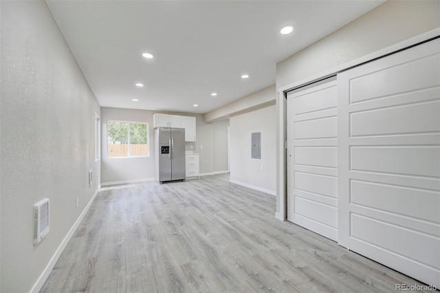 1216 Norwood Ave, Colorado Springs, CO 80905 - unfurnished living room featuring light wood finished floors, recessed lighting, and electric panel