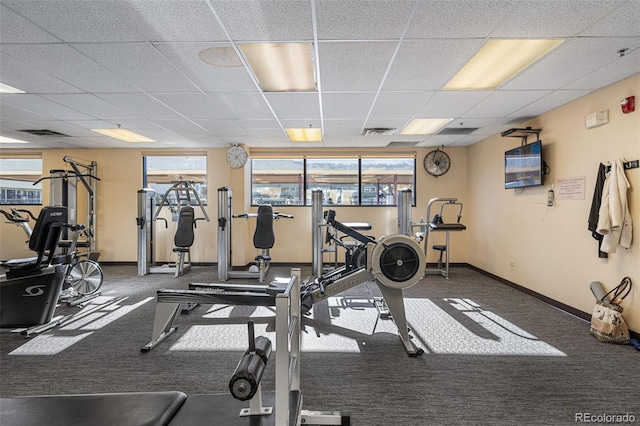 gym featuring a drop ceiling and dark colored carpet