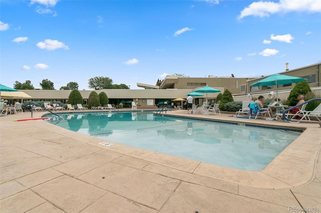 view of swimming pool with a patio