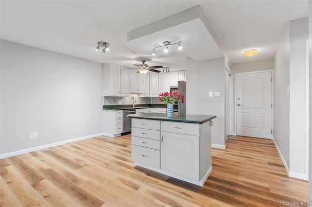 kitchen featuring white cabinetry, light hardwood / wood-style flooring, stainless steel appliances, and a kitchen island