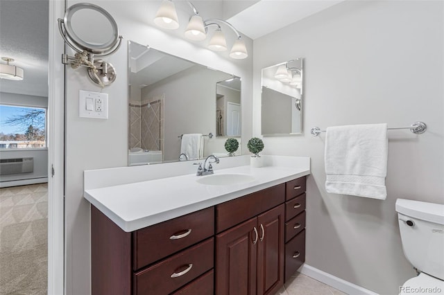 bathroom with vanity, toilet, and a textured ceiling