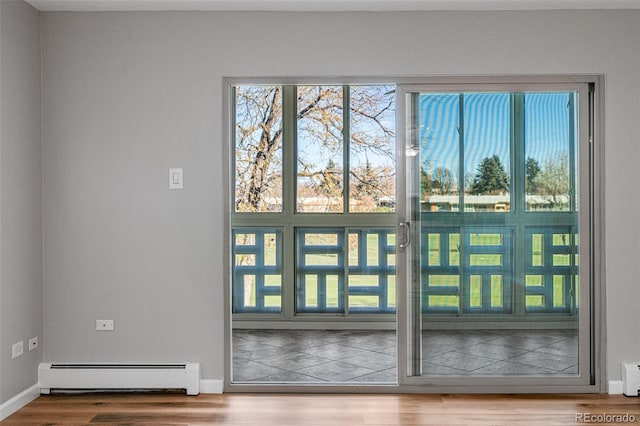 doorway featuring a baseboard radiator and wood-type flooring