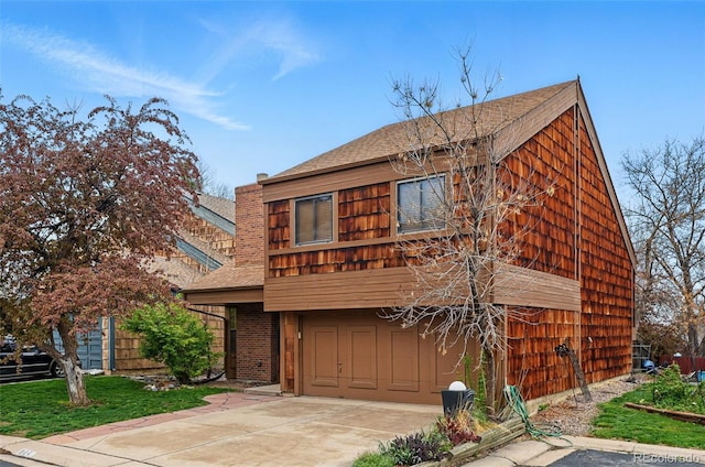10102 W Ida Ave Unit 214, Littleton, CO 80127 - view of front facade featuring an attached garage, roof with shingles, and concrete driveway