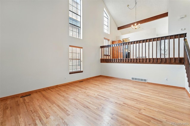 10102 W Ida Ave Unit 214, Littleton, CO 80127 - unfurnished room featuring a chandelier, wood finished floors, high vaulted ceiling, and baseboards