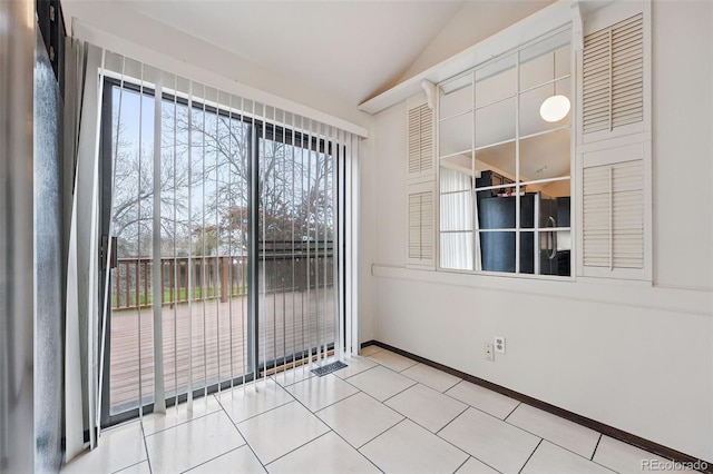 10102 W Ida Ave Unit 214, Littleton, CO 80127 - spare room with vaulted ceiling, baseboards, and tile patterned flooring