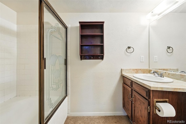 10102 W Ida Ave Unit 214, Littleton, CO 80127 - bathroom with vanity, combined bath / shower with glass door, and baseboards
