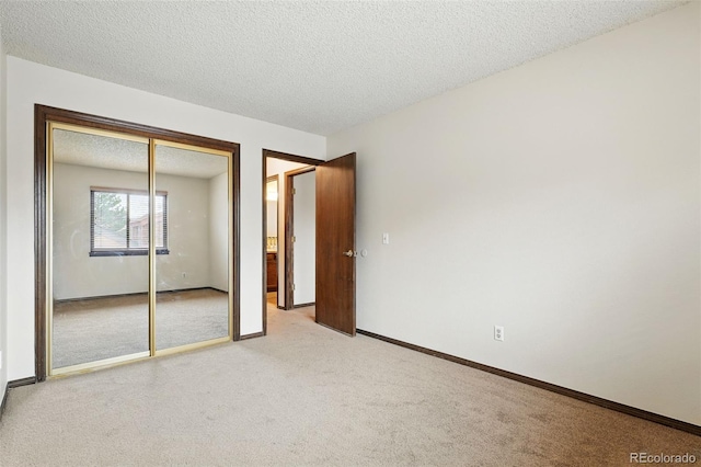 10102 W Ida Ave Unit 214, Littleton, CO 80127 - unfurnished bedroom featuring carpet, a textured ceiling, a closet, and baseboards