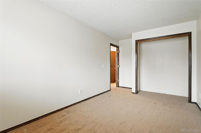 10102 W Ida Ave Unit 214, Littleton, CO 80127 - unfurnished bedroom with light colored carpet, a closet, and a textured ceiling