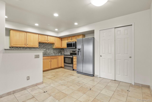 11085 Huron St Unit 1108, Northglenn, CO 80234 - kitchen with stainless steel appliances, decorative backsplash, light brown cabinets, recessed lighting, and light tile patterned flooring