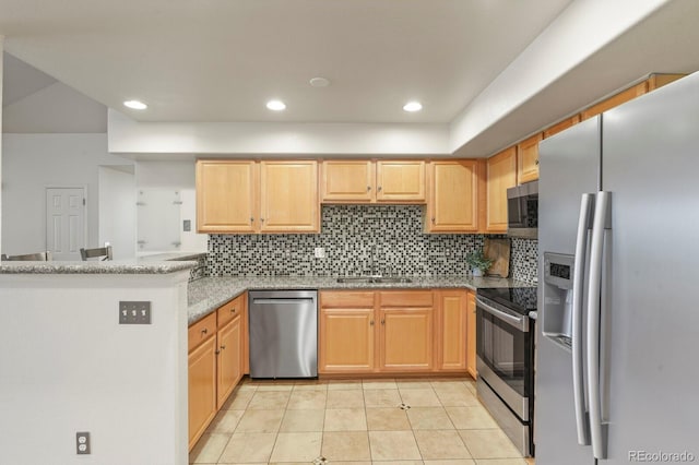 11085 Huron St Unit 1108, Northglenn, CO 80234 - kitchen with stainless steel appliances, light tile patterned floors, backsplash, light stone countertops, and a peninsula