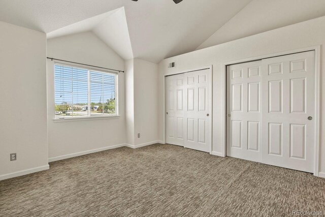 11085 Huron St Unit 1108, Northglenn, CO 80234 - unfurnished bedroom with two closets, lofted ceiling, and carpet flooring