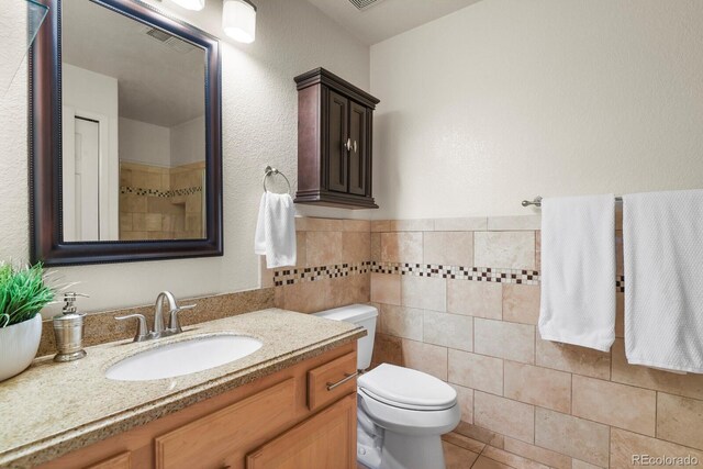 11085 Huron St Unit 1108, Northglenn, CO 80234 - bathroom with vanity, tile patterned floors, and tile walls